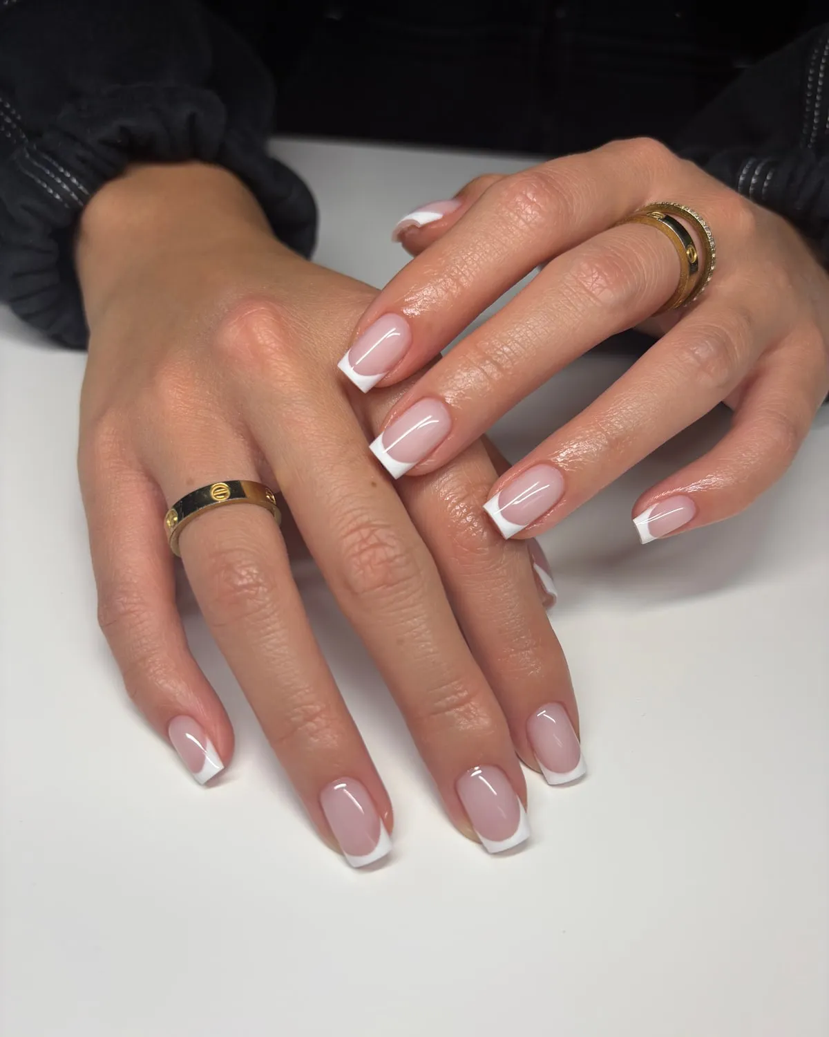 Hands with a clean French manicure at Kató Beauty in Tampa