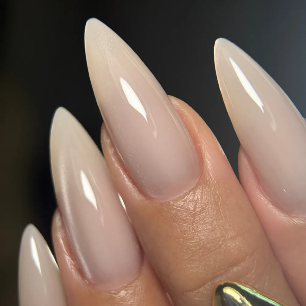 Polygel nail extensions in a glossy neutral tone